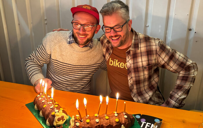 Neil and Jonny blowing candle out on their birthday cake