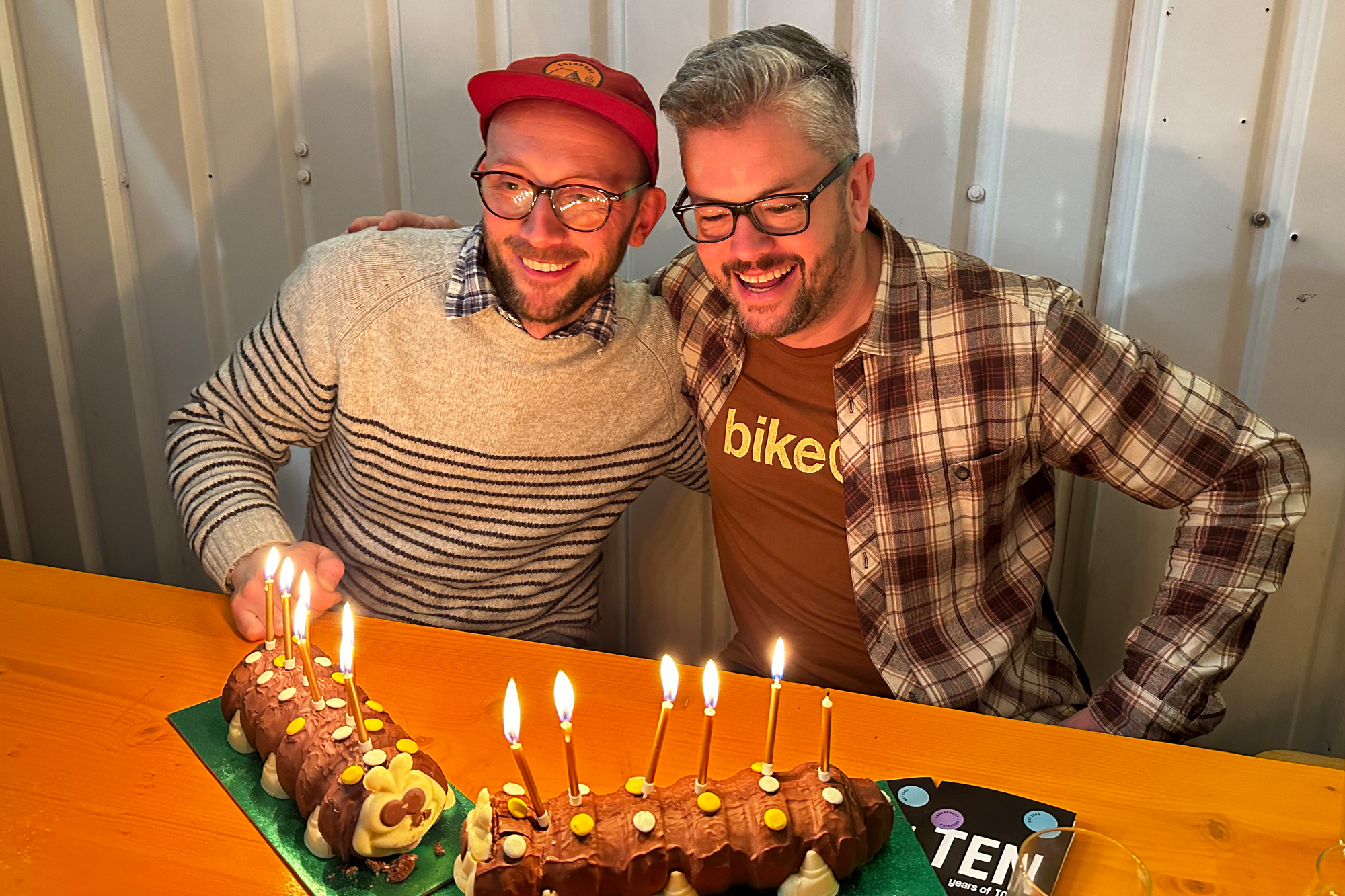 Neil and Jonny blowing candle out on their birthday cake